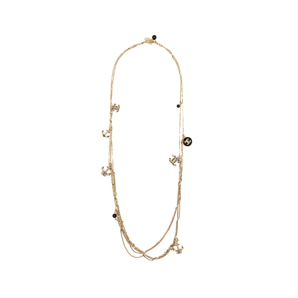 Chanel long necklace with multi charms light gold tone